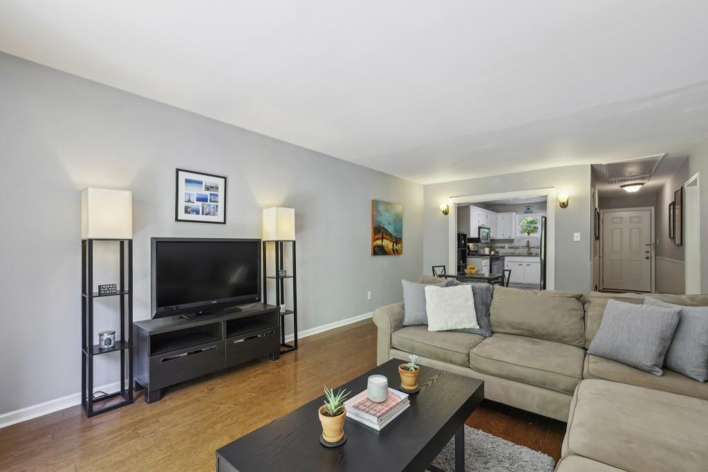 5400 Roswell Road, Unit H5 Atlanta, GA 30342 - Photo 15 of 26 a living room with furniture and a flat screen tv