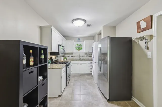 a kitchen with a refrigerator and a stove