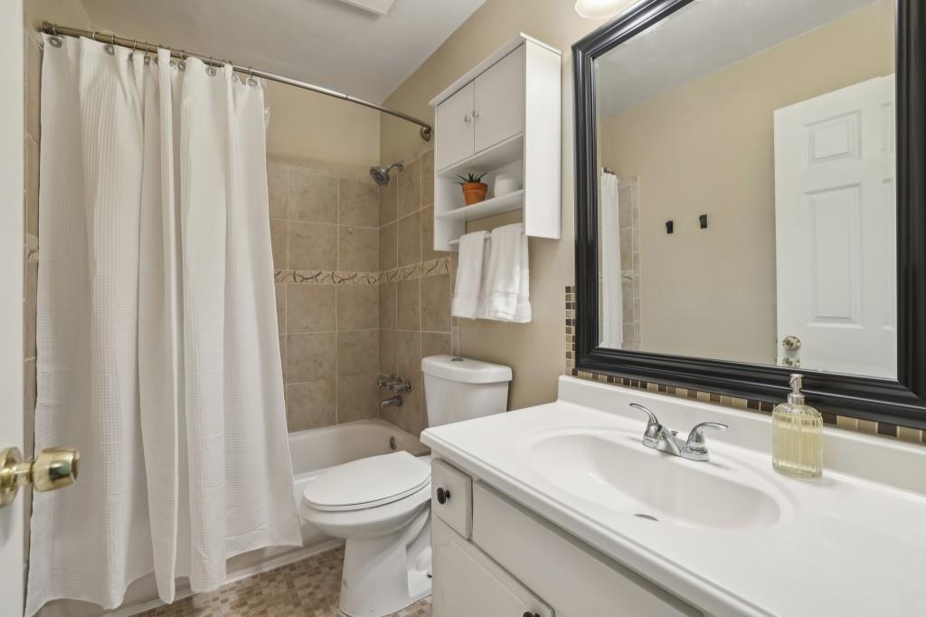 5400 Roswell Road, Unit H5 Atlanta, GA 30342 - Photo 5 of 26 a bathroom with a sink a toilet and shower