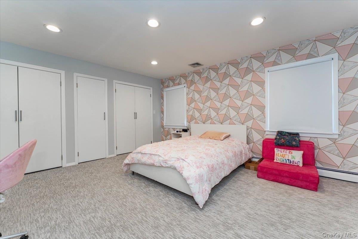22 Larch Hill Road Lawrence, NY 11559 - Photo 16 of 31 a bedroom with a bed and a couch