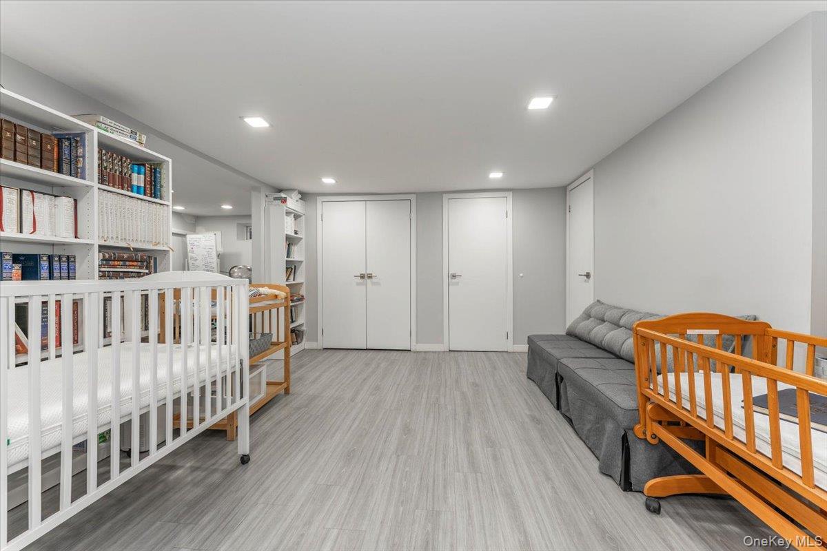 22 Larch Hill Road Lawrence, NY 11559 - Photo 19 of 31 a view of a bedroom with furniture and staircase