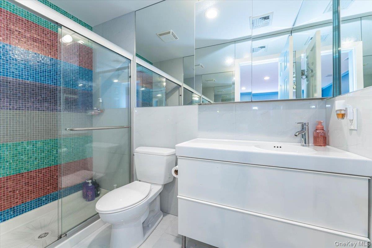 22 Larch Hill Road Lawrence, NY 11559 - Photo 22 of 31 a bathroom with a sink a toilet and shower