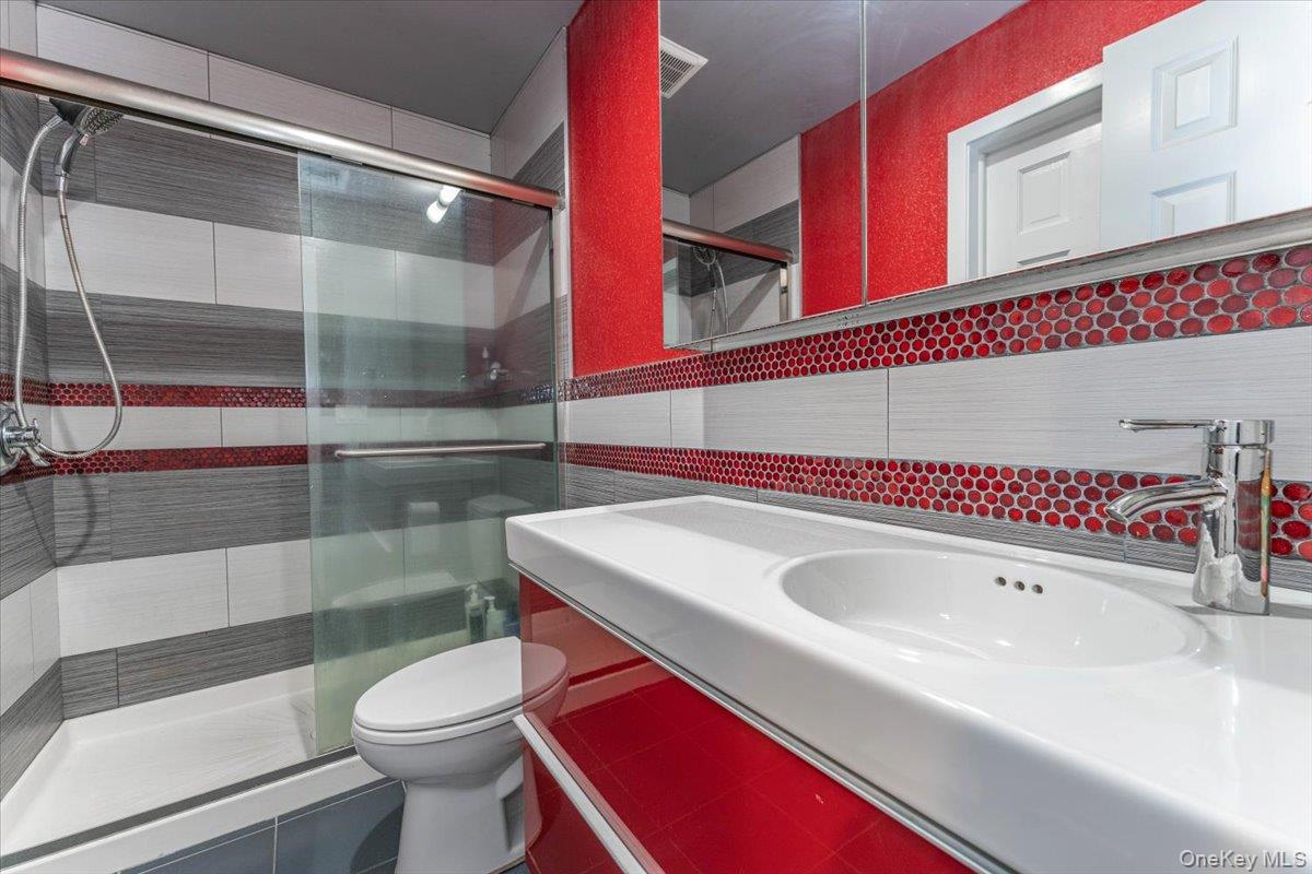 22 Larch Hill Road Lawrence, NY 11559 - Photo 23 of 31 a bathroom with a sink a toilet and shower