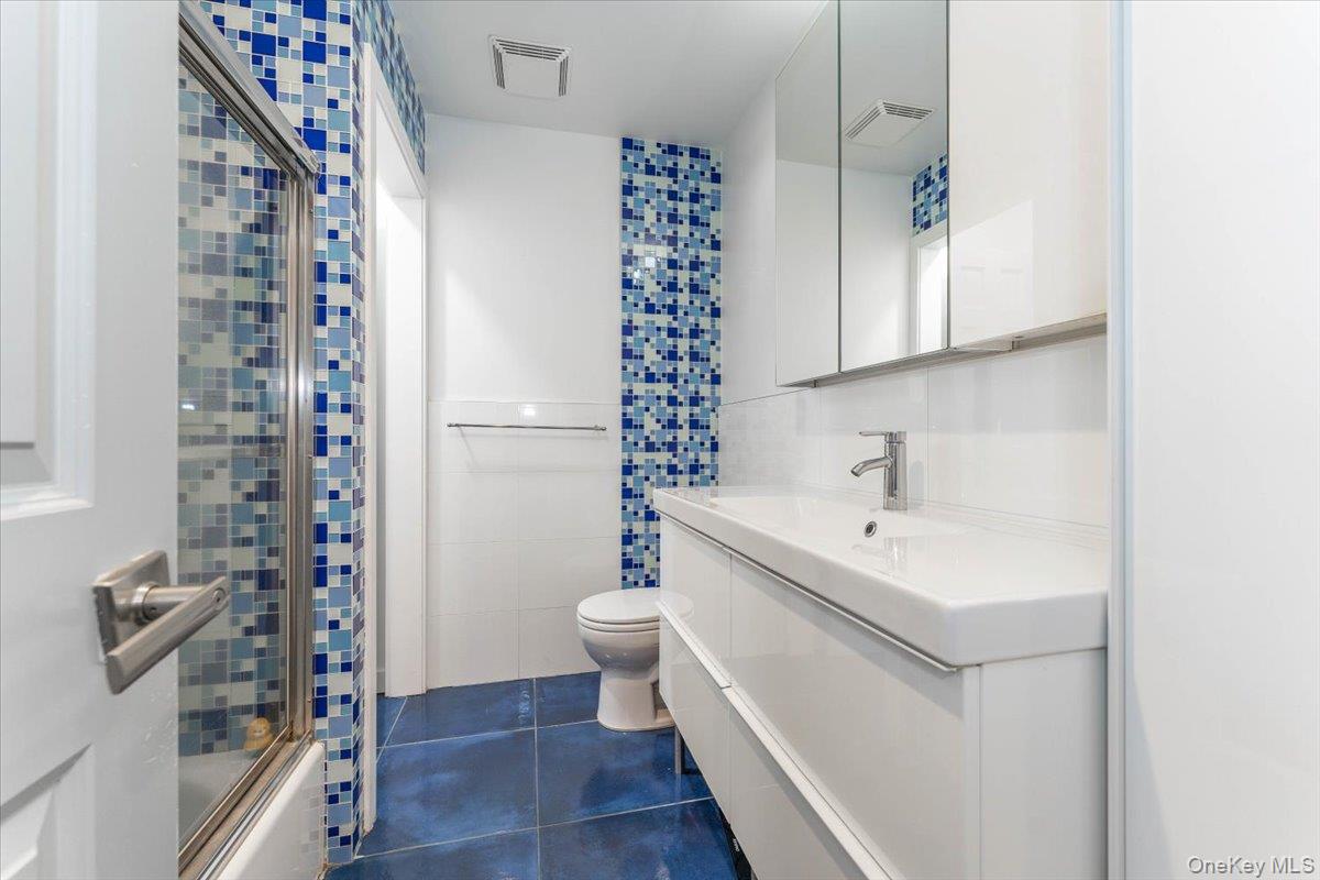 22 Larch Hill Road Lawrence, NY 11559 - Photo 24 of 31 a bathroom with a sink a toilet and shower