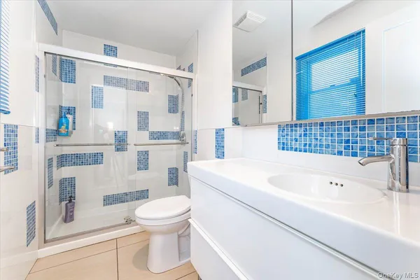 a bathroom with a sink a toilet and a mirror