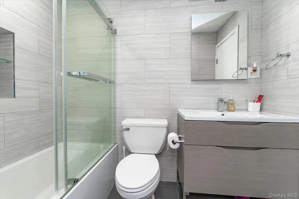 a bathroom with a sink a toilet a mirror and vanity
