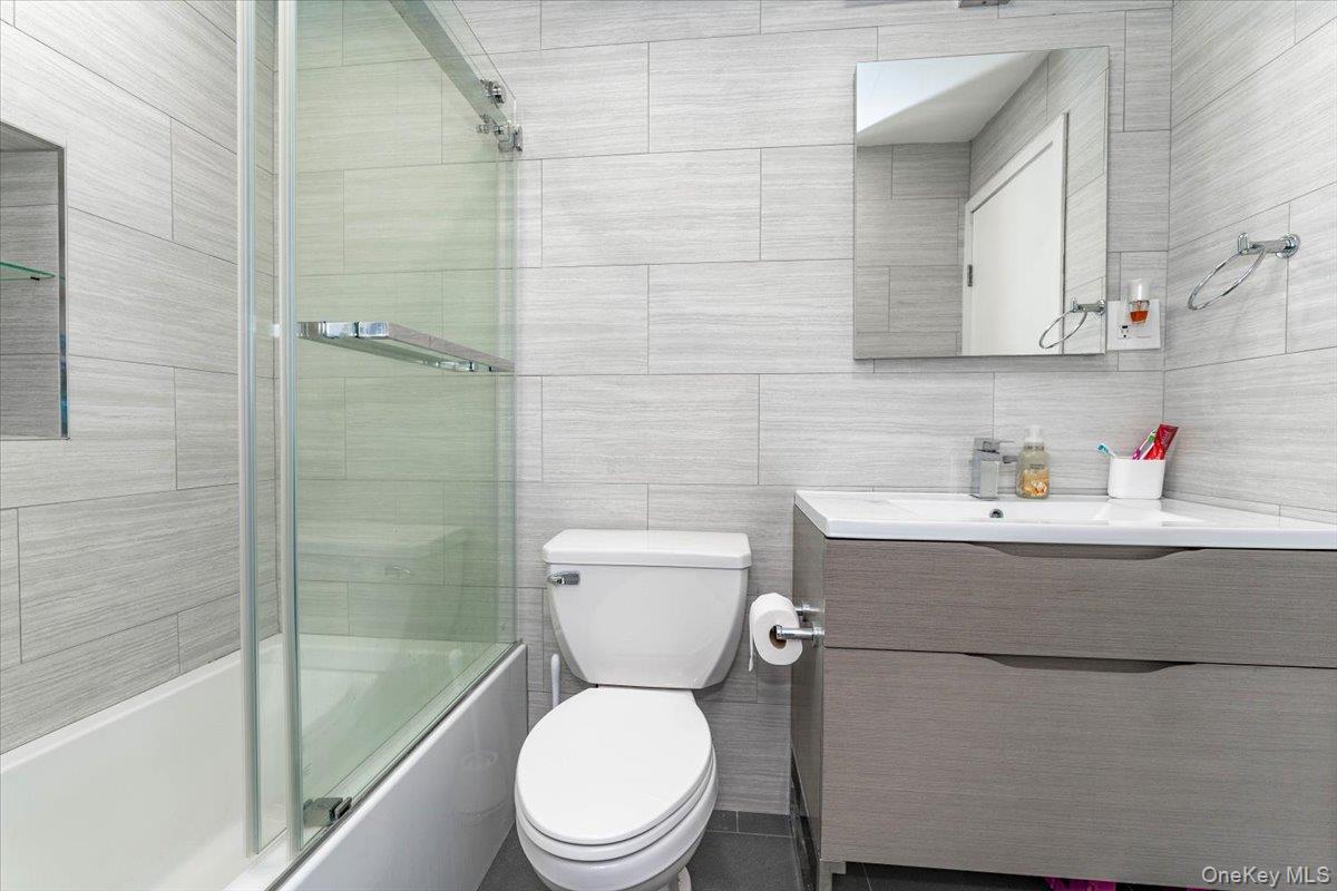 22 Larch Hill Road Lawrence, NY 11559 - Photo 28 of 31 a white toilet sitting next to a bath tub and a shower
