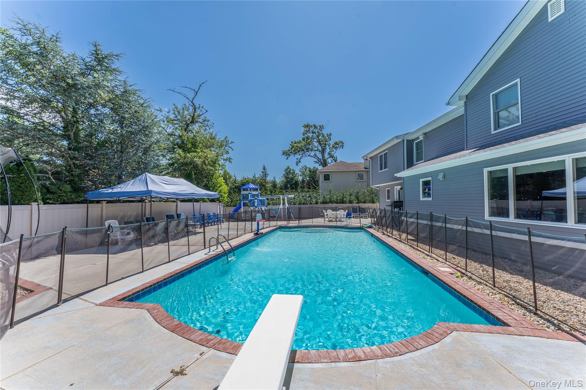 22 Larch Hill Road Lawrence, NY 11559 - Photo 30 of 31 a view of a swimming pool with a patio
