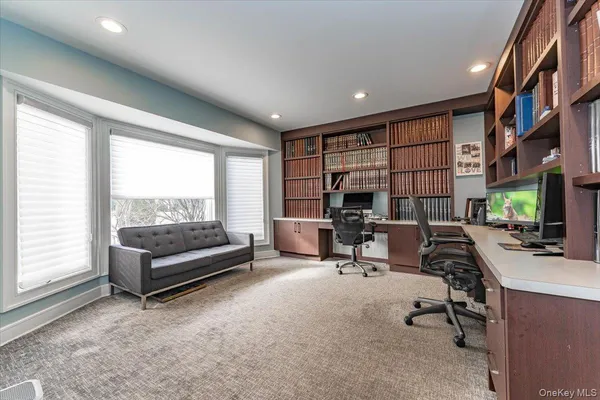 a view of a livingroom with workspace and a window