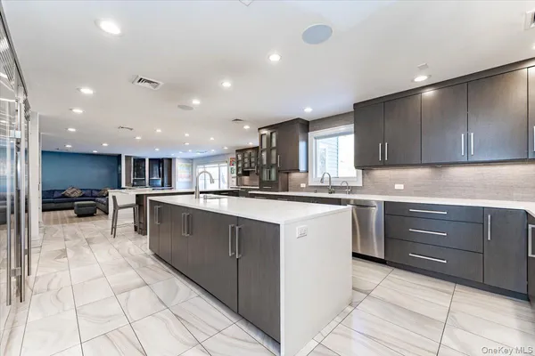 a kitchen with stainless steel appliances granite countertop a refrigerator and a sink