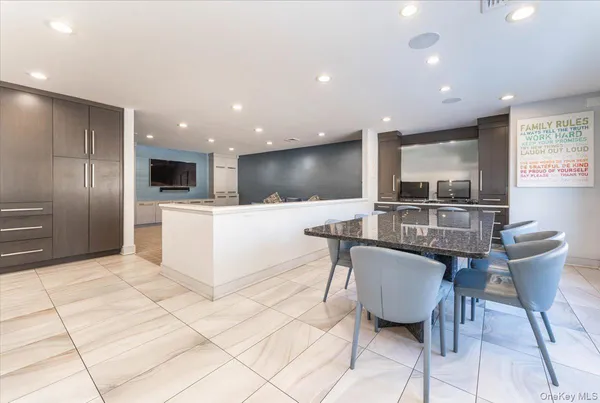 a kitchen with stainless steel appliances kitchen island granite countertop a sink and cabinets