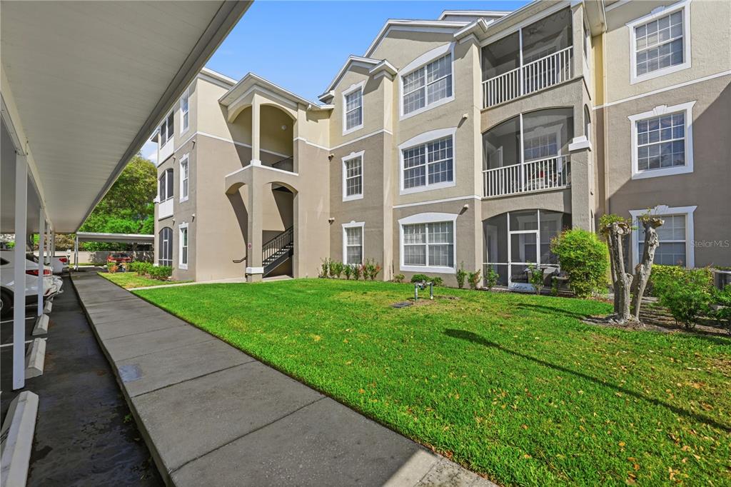 580 Brantley Terrace Way, Unit 104 Altamonte Springs, FL 32714 - Photo 28 of 32 a view of a building next to a big yard
