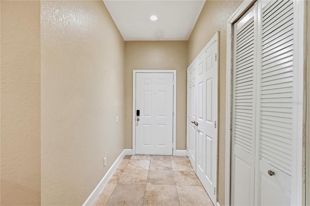 580 Brantley Terrace Way, Unit 104 Altamonte Springs, FL 32714 - Photo 4 of 32 a view of a hallway with wooden floor