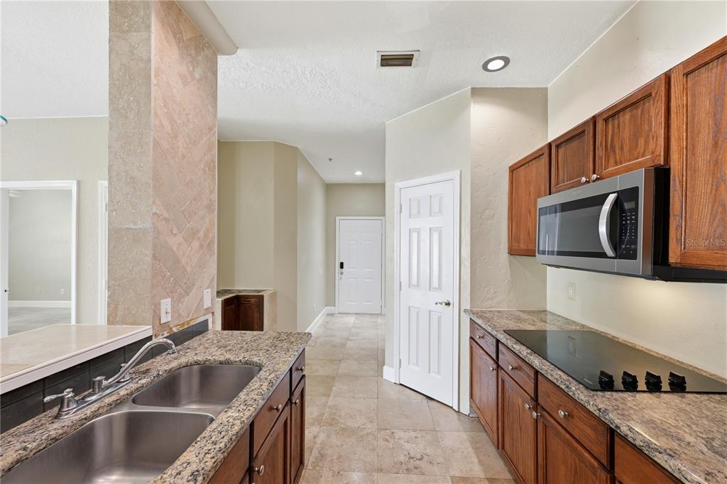 580 Brantley Terrace Way, Unit 104 Altamonte Springs, FL 32714 - Photo 9 of 32 a kitchen with stainless steel appliances granite countertop a sink and a stove