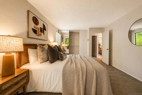 a bedroom with a large bed and a window