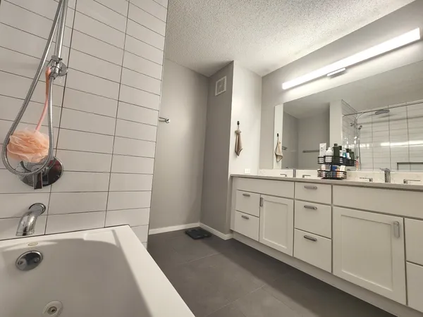 a bathroom with a double vanity sink toilet and mirror