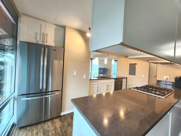 a kitchen with stainless steel appliances granite countertop a granite counter tops and a wooden floors