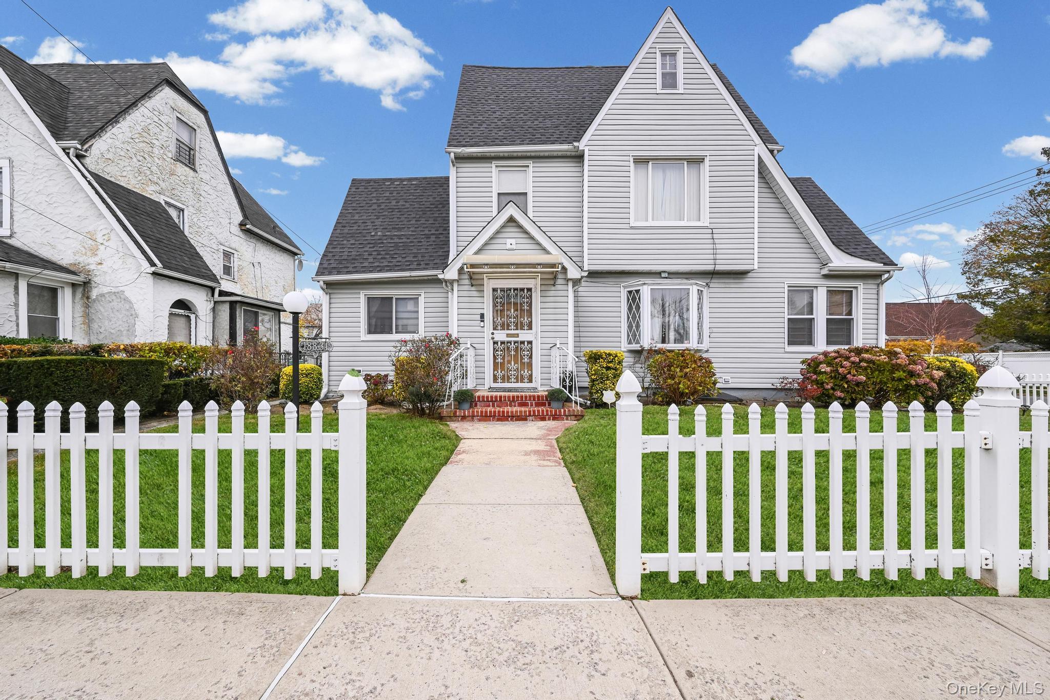 a front view of a house with a garden