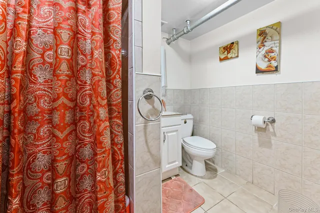 a white toilet sitting next to a shower curtain