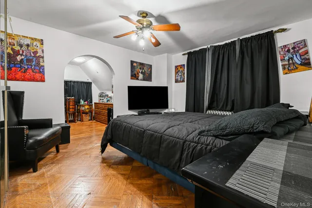 a bed room with a bed a television and dresser