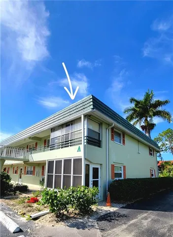 a front view of a building with garden