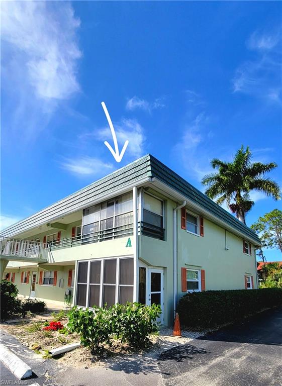 300 Valley Stream Drive, Unit A7 Naples, FL 34113 - Photo 12 of 34 a front view of a building with garden
