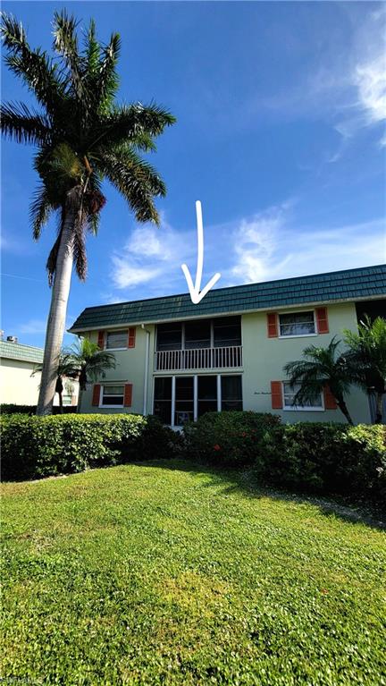 300 Valley Stream Drive, Unit A7 Naples, FL 34113 - Photo 13 of 34 a front view of a house with garden