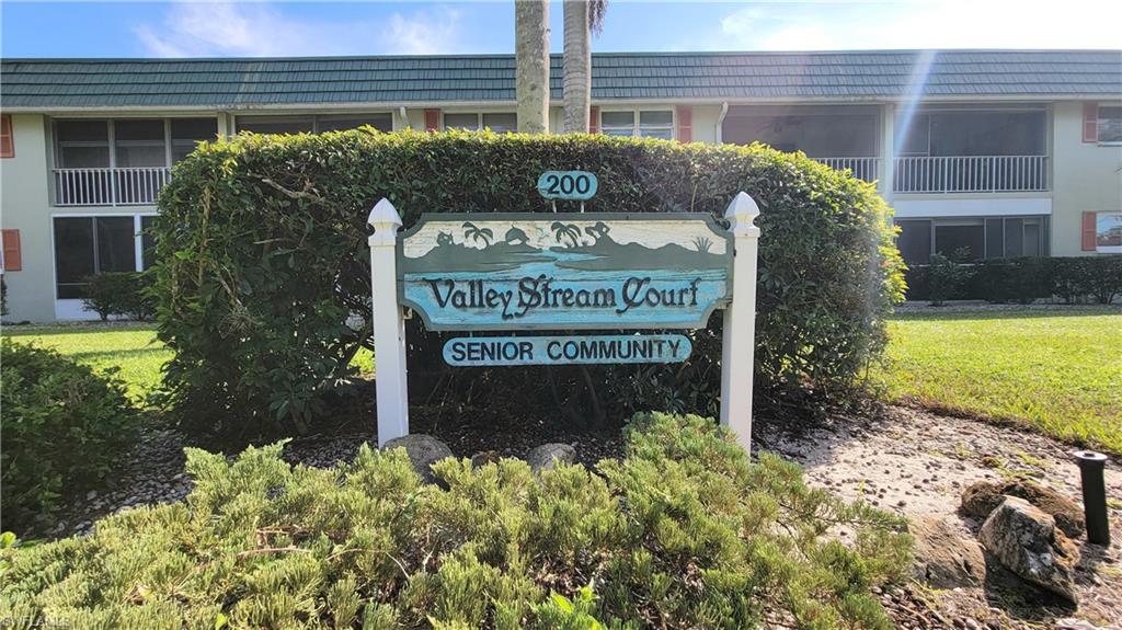 300 Valley Stream Drive, Unit A7 Naples, FL 34113 - Photo 14 of 34 a sign on the side of a building