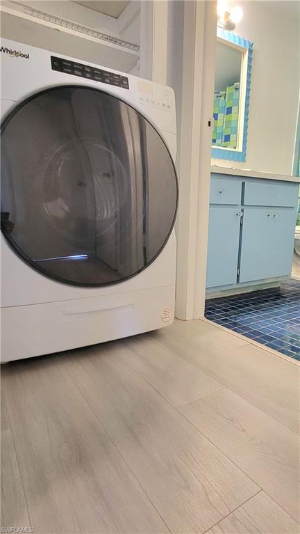 300 Valley Stream Drive, Unit A7 Naples, FL 34113 - Photo 18 of 34 a utility room with wooden floor and white walls