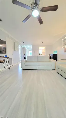 a living room with furniture and a floor to ceiling window