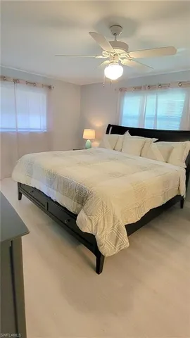 a spacious bedroom with a bed and a chandelier