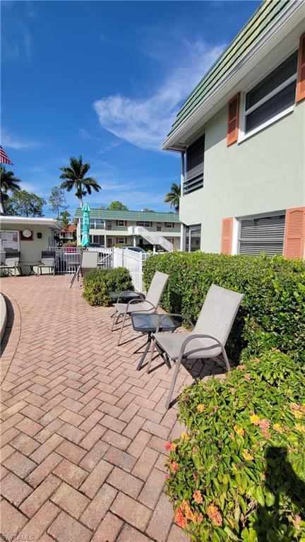 300 Valley Stream Drive, Unit A7 Naples, FL 34113 - Photo 8 of 34 a view of a terrace with chairs