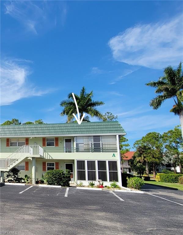 300 Valley Stream Drive, Unit A7 Naples, FL 34113 - Photo 9 of 34 a front view of a building with a garden and plants