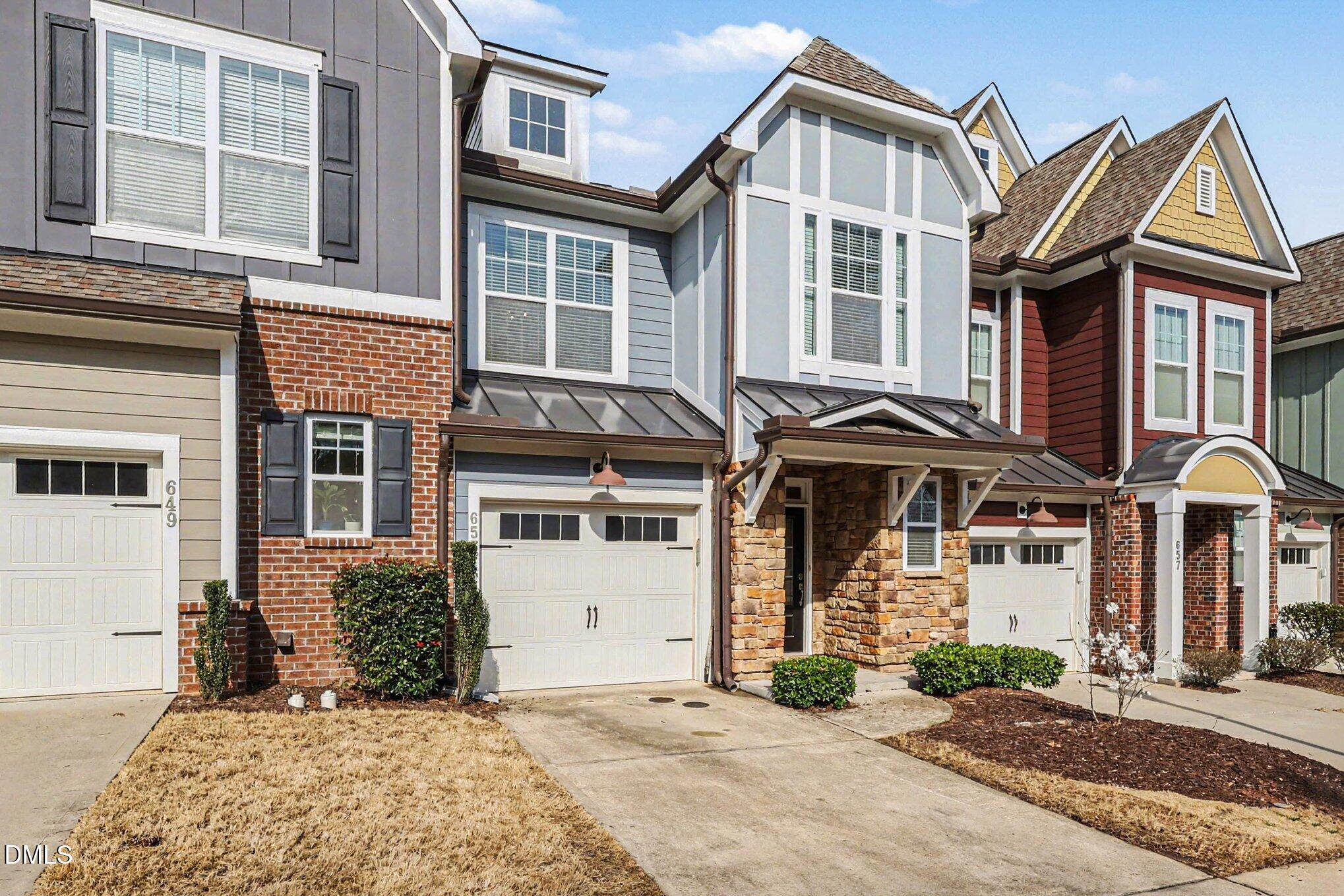 653 Fallon Grove Way Raleigh, NC 27608 - Photo 3 of 38 a front view of a house with a yard