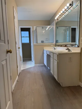 a view of a bathroom with a sink and mirror