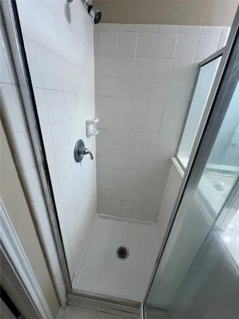 a bathroom with a glass shower door