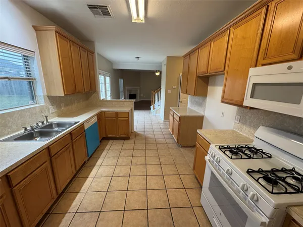a kitchen with a sink a stove and refrigerator
