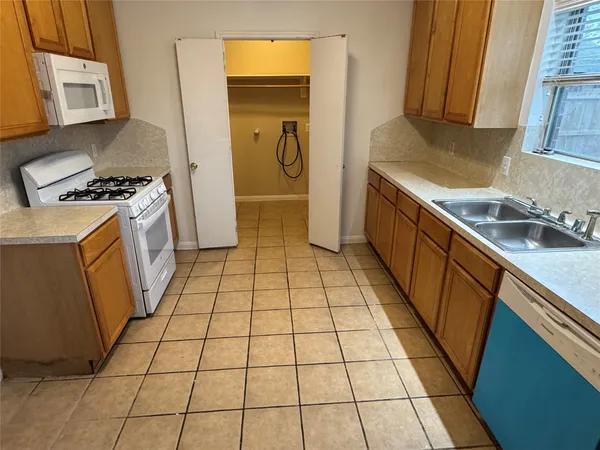 a kitchen with a sink a stove and a refrigerator