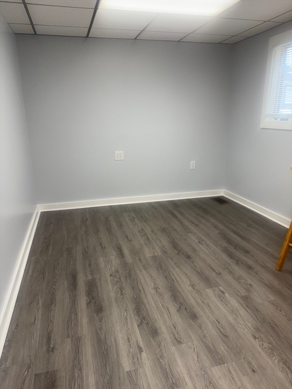 353 Cabot Street, Unit 1 Beverly, MA 01915 - Photo 5 of 18 a view of an empty room with wooden floor and a window