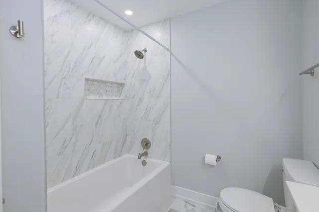 a bathroom with a toilet and a bathtub