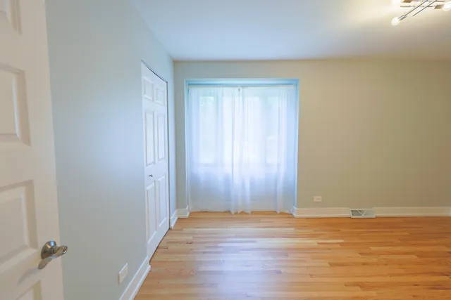 a view of a room with wooden floor