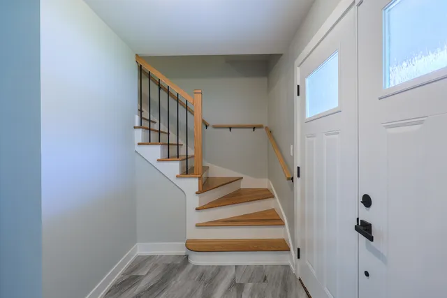 a view of entryway with wooden floor and stairs
