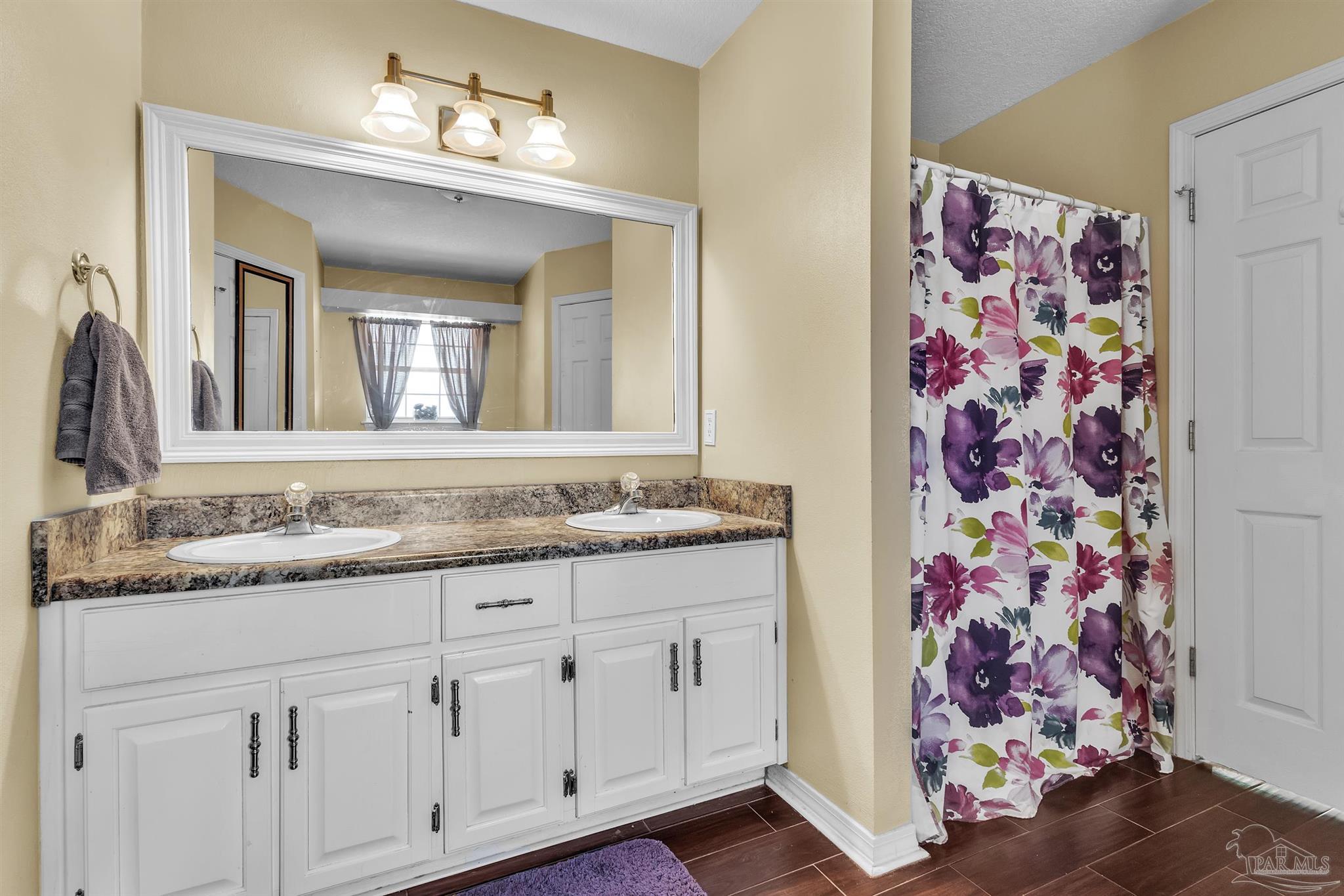 4321 Ridgeland Drive Pace, FL 32571 - Photo 17 of 36 a bathroom with a granite countertop sink and a mirror