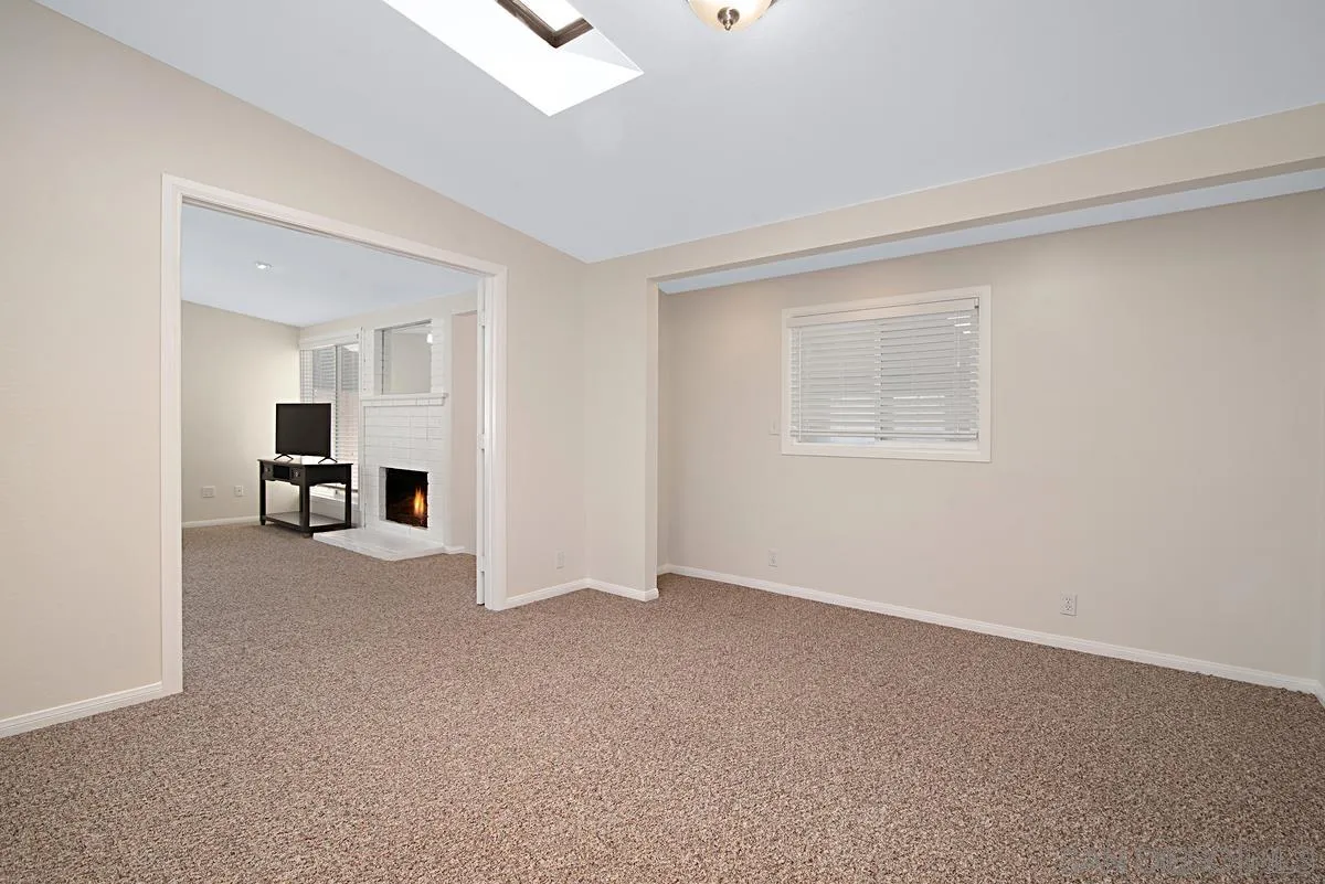 13836 Powers Road Poway, CA 92064 - Photo 17 of 27 an empty room with a kitchen and window