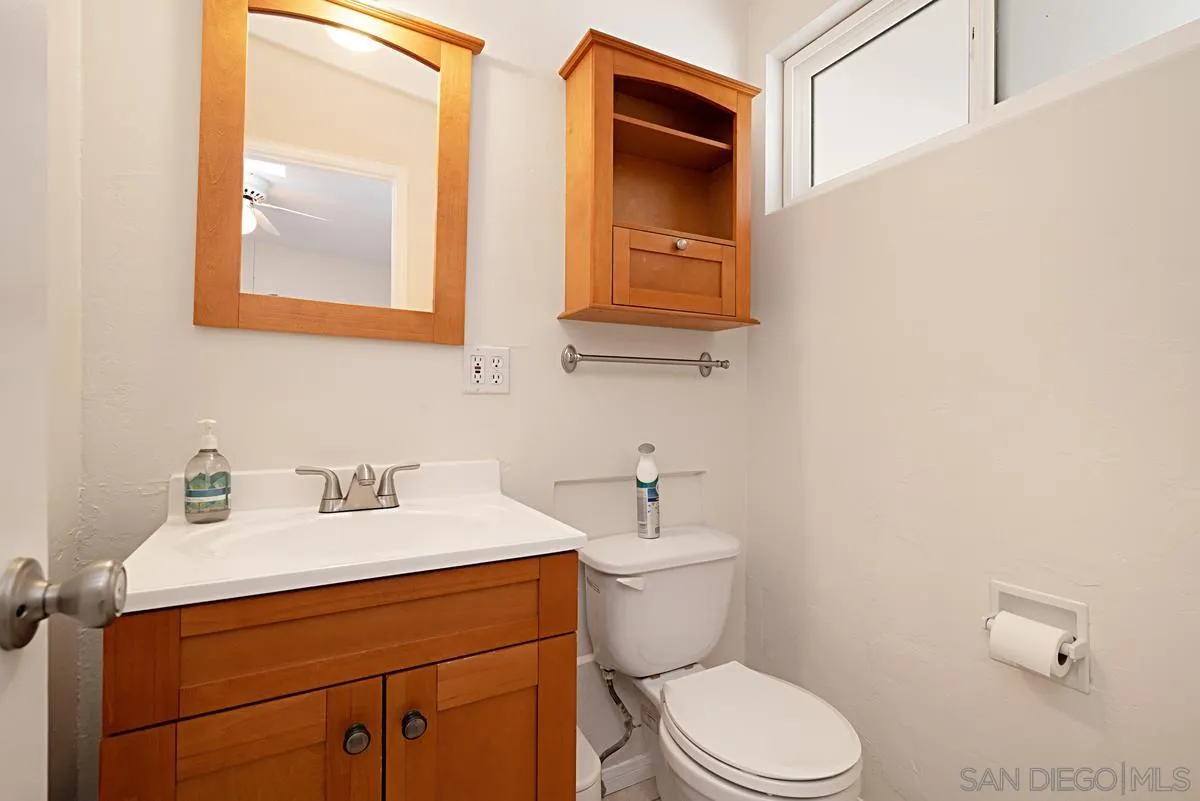 13836 Powers Road Poway, CA 92064 - Photo 21 of 27 a bathroom with a toilet sink vanity and mirror