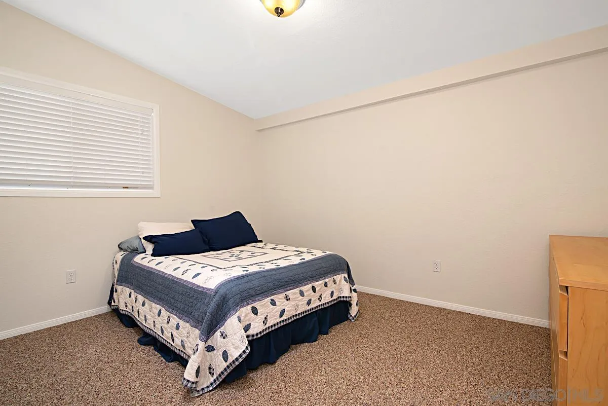 13836 Powers Road Poway, CA 92064 - Photo 22 of 27 a bedroom with a bed and a window