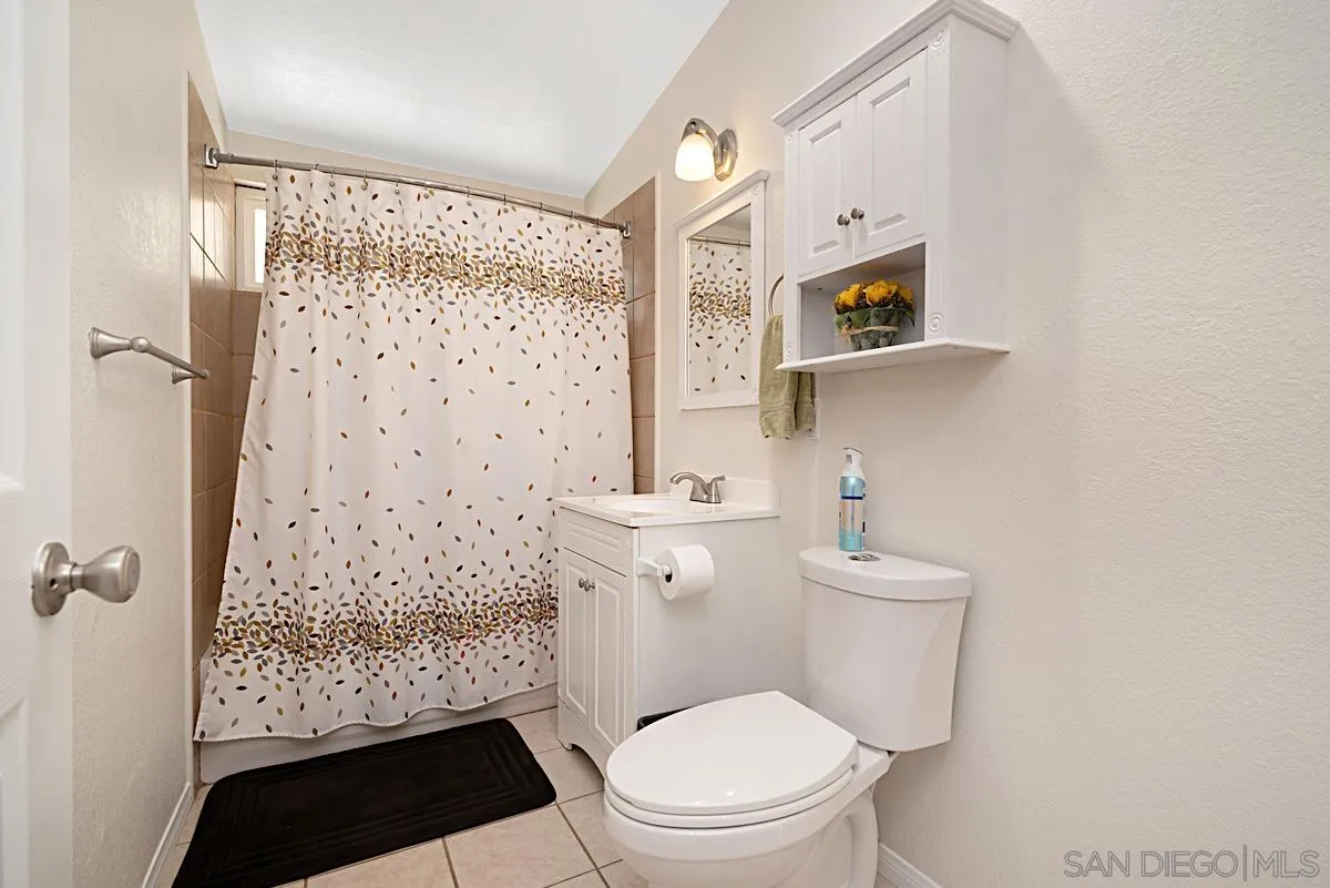 13836 Powers Road Poway, CA 92064 - Photo 23 of 27 a bathroom with a toilet a sink and a shower