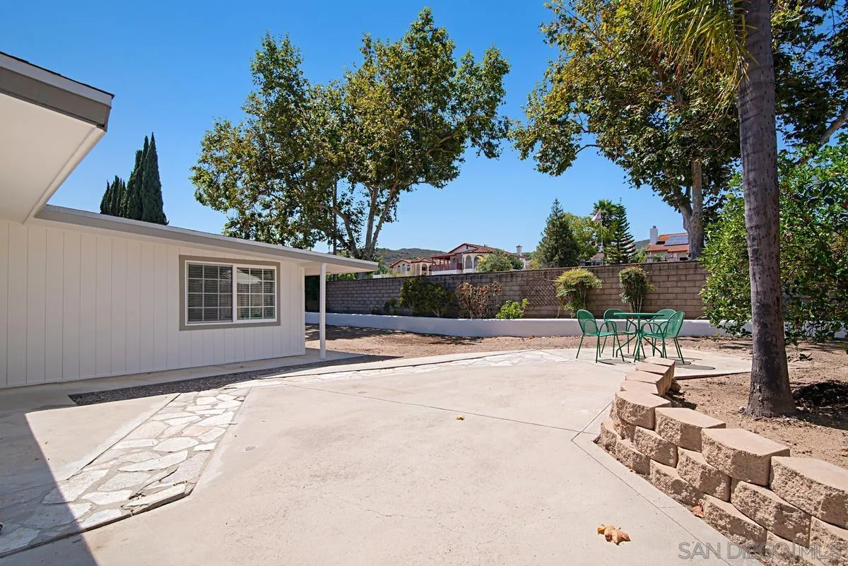 13836 Powers Road Poway, CA 92064 - Photo 27 of 27 a backyard of a house with table and chairs plants and large trees