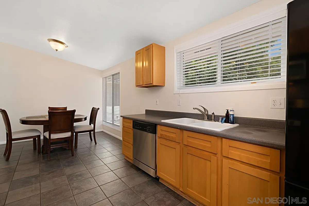 13836 Powers Road Poway, CA 92064 - Photo 10 of 27 a kitchen with granite countertop sink table and chairs