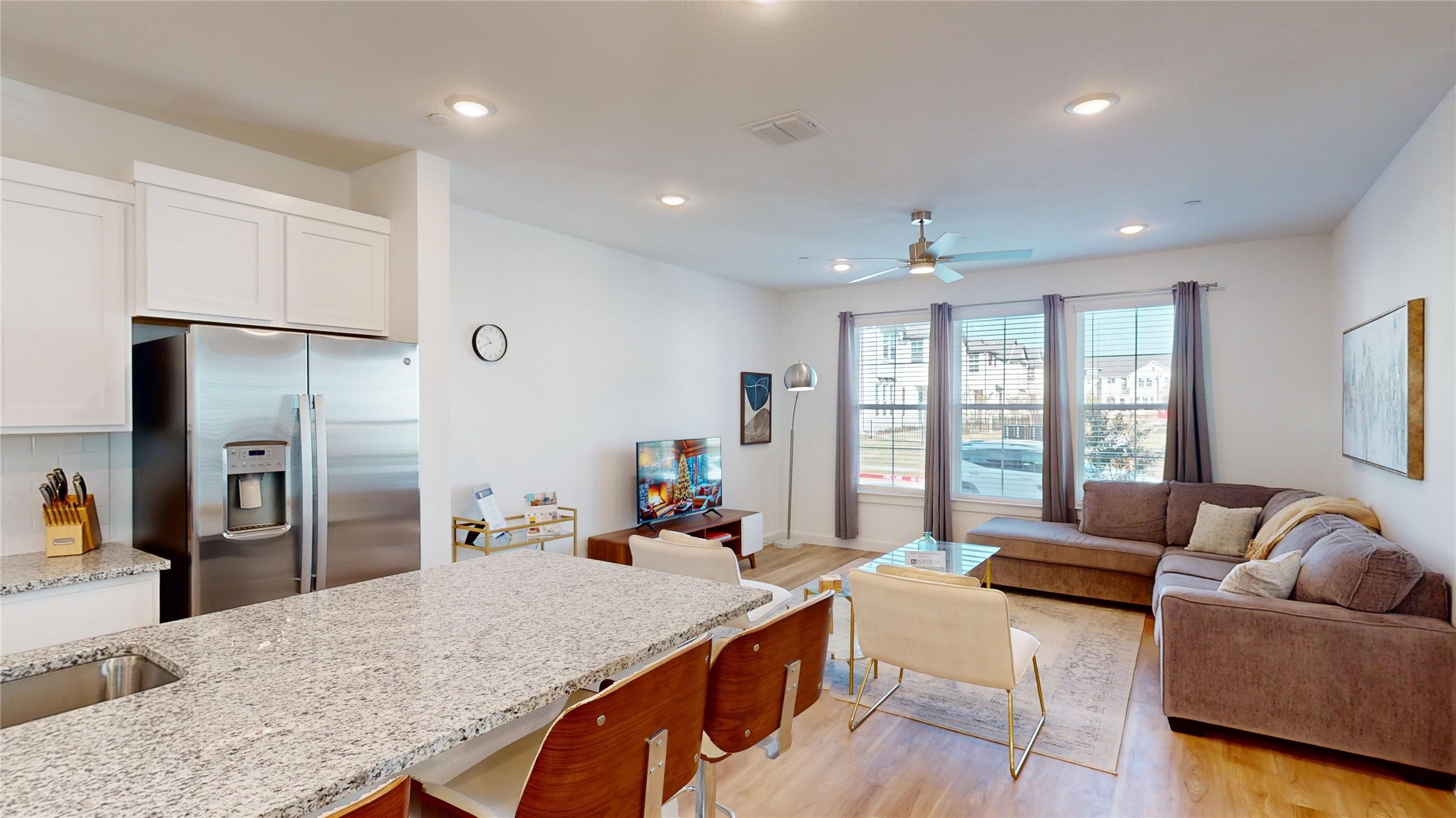 2906 ELLE Drive Grand Prairie, TX 75052 - Photo 12 of 47 a large living room with stainless steel appliances granite countertop a refrigerator a sink dishwasher a dining table and chairs with wooden floor